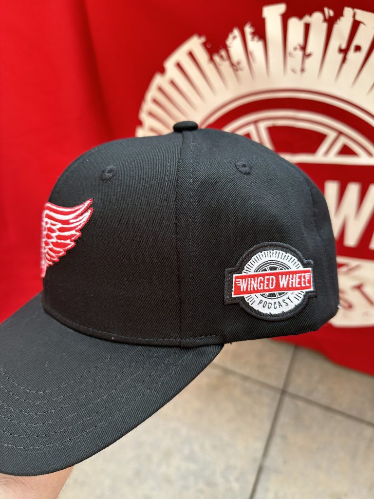 Event-day cap photo — close side view showing WWP patch against red backdrop