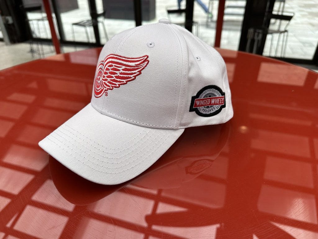 White cap photographed at venue — closer WWP side angle